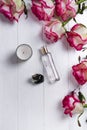 Perfume bottle, candle and pink rose Royalty Free Stock Photo