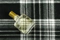 Perfume bottle on check pattern Royalty Free Stock Photo