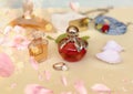 Perfume bottle red  glass   with flowers petal on white gold background ,women accessories Royalty Free Stock Photo