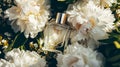 Perfume bottle in flowers, fragrance on blooming background, floral scent and cosmetic product Royalty Free Stock Photo