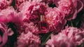 Perfume bottle in flowers, fragrance on blooming background, floral scent and cosmetic product Royalty Free Stock Photo