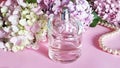 Perfume bottle with flowers and pearl necklace o Royalty Free Stock Photo