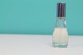 Perfume bottle with light blue cover isolated white and blue background Royalty Free Stock Photo