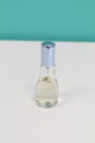 Perfume bottle with light blue cover isolated white and blue background Royalty Free Stock Photo