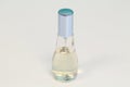 Perfume bottle with light blue cover white and blue background Royalty Free Stock Photo