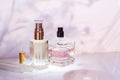 Perfume bottle on a light pink floral background. Selective focus. Perfumery collection, cosmetics Royalty Free Stock Photo