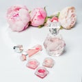 Perfume bottle, nail polish, lipstick. Fashion woman still life. Pop female things with flowers on white background.