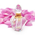 Perfume bottle with necklace among flower petals on white background. Perfumery, cosmetics, fragrance collection Royalty Free Stock Photo