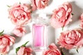 Perfume bottle in pink flower roses. Spring background with luxury aroma parfume. Beauty cosmetic shot Royalty Free Stock Photo