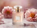 Perfume bottle with pink flowers on a white reflective background. Royalty Free Stock Photo
