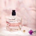 Perfume bottle with plants on a light pink floral background. Selective focus. Perfumery collection, cosmetics