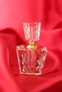 Perfume bottle and red satin Royalty Free Stock Photo