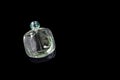 Perfume bottle with reflection on black background. Perfumery, cosmetics. Copyspace for text.