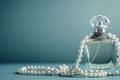 perfume bottle with string of pearls draped over it Royalty Free Stock Photo