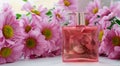 A perfume bottle surrounded by pink chrysanthemum flowers. Eau de toilette, eau de parfum, beauty concept Royalty Free Stock Photo