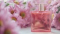 A perfume bottle surrounded by pink chrysanthemum flowers. Eau de toilette, eau de parfum, beauty concept Royalty Free Stock Photo