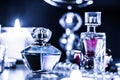 Perfume bottle and vintage fragrance on glamour vanity table at night, pearls jewellery and eau de parfum as holiday gift, luxury Royalty Free Stock Photo