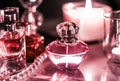 Perfume bottle and vintage fragrance on glamour vanity table at night, pearls jewellery and eau de parfum as holiday gift, luxury Royalty Free Stock Photo