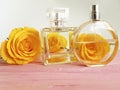 Perfume bottle yellow rose on a wooden decoration