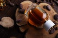 Perfume bottles around ingredients  on juniper wooden. close up Royalty Free Stock Photo