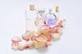 Perfume bottles with flower petals on light background. Perfumery, fragrance collection. Women accessories. Royalty Free Stock Photo