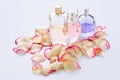 Perfume bottles with flower petals on light background. Perfumery, fragrance collection. Women accessories. Royalty Free Stock Photo