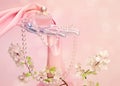 Perfume, a branch of Apple blossoms, beads and pink silk scarf i Royalty Free Stock Photo