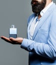 Perfume or cologne bottle, perfumery, cosmetics, scent cologne bottle, male holding cologne. Masculine perfumery