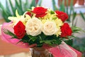 Perfume. Flower fragrance. Floral arrangement. Lovely perfumed bouquet with red roses, chrysanthemums and lilies in ceramic vase