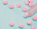 Perfume spray bottle and small pink roses Royalty Free Stock Photo