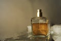 The perfume in a square bottle gray background The bottom is wet, beautiful, luxurious, fragrant Royalty Free Stock Photo