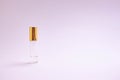 Perfume tester. Small perfume glass bottle with gold cap. Space text. The concept of minimalism. mockup.