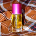 Perfume on a two-tone plaid background Royalty Free Stock Photo