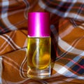 Perfume on a two-tone plaid background Royalty Free Stock Photo