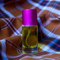 Perfume on a two-tone plaid background Royalty Free Stock Photo