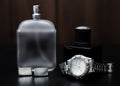 Perfume and watches on a wooden background. Men`s Accessori