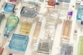 Perfumery, cosmetics and beauty industry background. A lot of transparent bottles of perfume and cologne and toilet