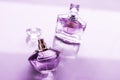 Purple perfume bottle on glossy background, sweet floral scent, glamour fragrance and eau de parfum as holiday gift and luxury Royalty Free Stock Photo