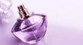 Purple perfume bottle on glossy background, sweet floral scent, glamour fragrance and eau de parfum as holiday gift and luxury Royalty Free Stock Photo