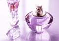 Purple perfume bottle on glossy background, sweet floral scent, glamour fragrance and eau de parfum as holiday gift and luxury Royalty Free Stock Photo