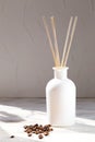 Aromatic reed diffuser with coffee beans on a white background Royalty Free Stock Photo