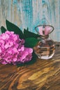 Perfumes and hydrangea on a blue wooden background