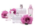 Perfumes with roses on white background