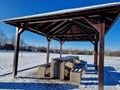 Pergola, garden pavilion is equipped with a metal grill.