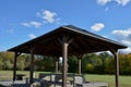 Pergola, garden pavilion is equipped with a metal grill. public barbecue place in the park. the pergola is equipped with tables an