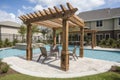 pergola and gazebo over pool surrounded by lounge chairs