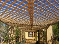 Pergola with a reed roof to shade the garden