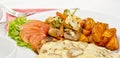 Peri peri Chicken with Button mushroom gravy, Saute Vegetables, Spicy fried Potatoes with Tomato Lettuce Salad Royalty Free Stock Photo