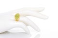 Peridot and Diamond Jewel or gems ring on plastic mannequin female hand. Collection of natural gemstones accessories. Studio shot