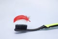 Periodontitis, gingivitis, bleeding gums, hygiene photo of periodontal disease. A photo of the black toothbrush and a red feather